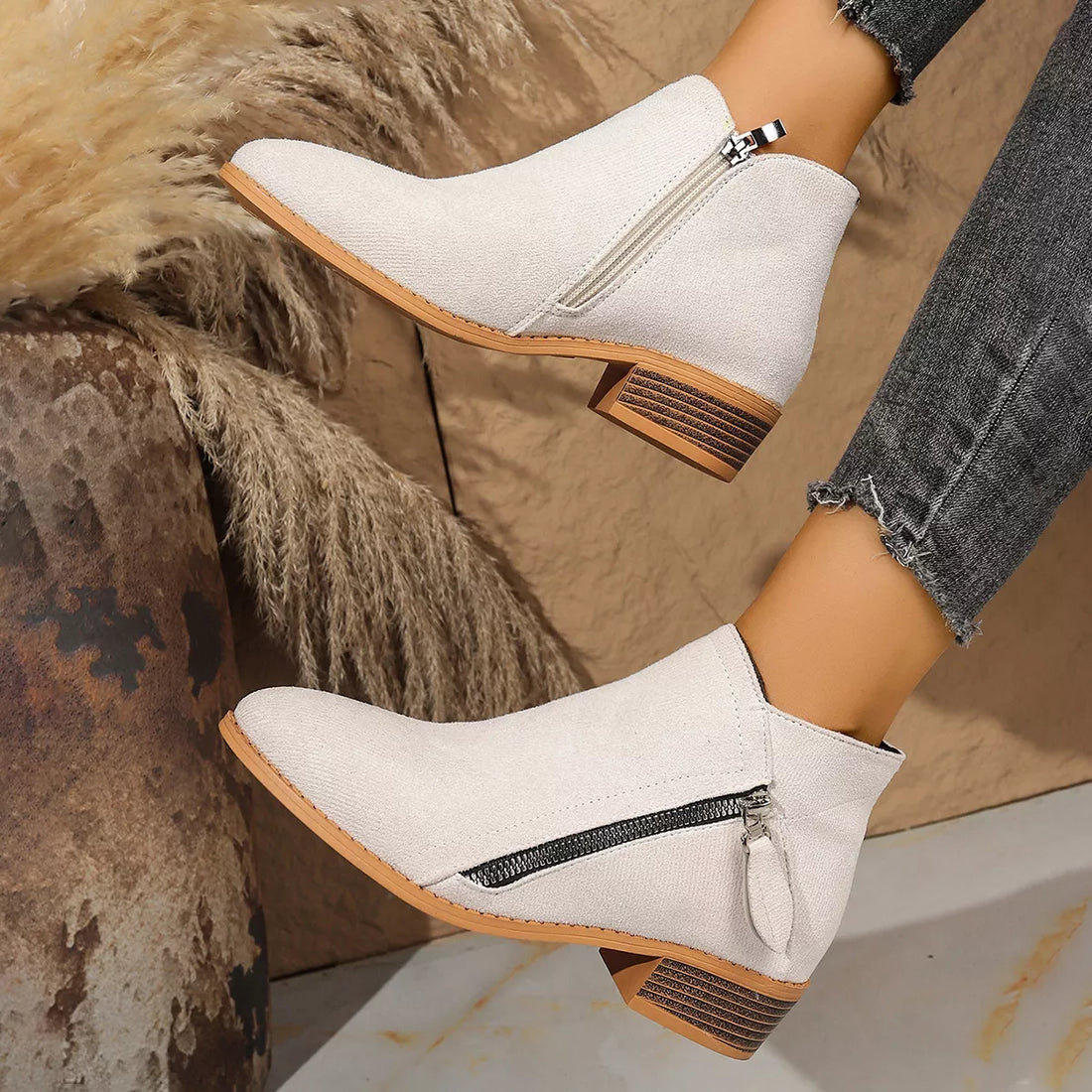 White point-toe block heeled ankle boots with side zipper and brown-striped block heel