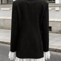 Back view of black one-button blazer with lace-trim hem