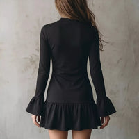 Black long-sleeve mini dress, back view, with ruffle hem and flared cuffs