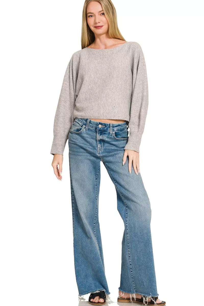 Grey boat-neck knit sweater with long sleeves and relaxed straight hem