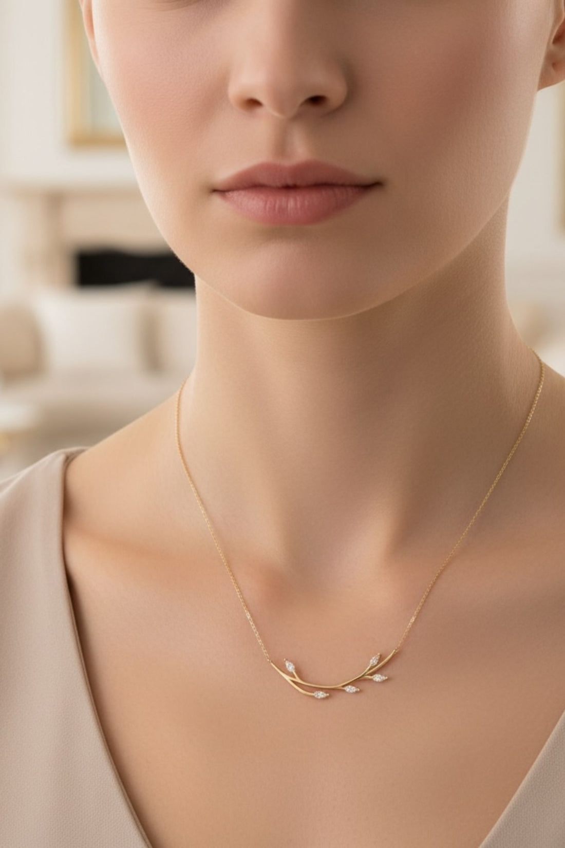 14k gold blooming branch necklace close-up at neckline, delicate leaf pendant