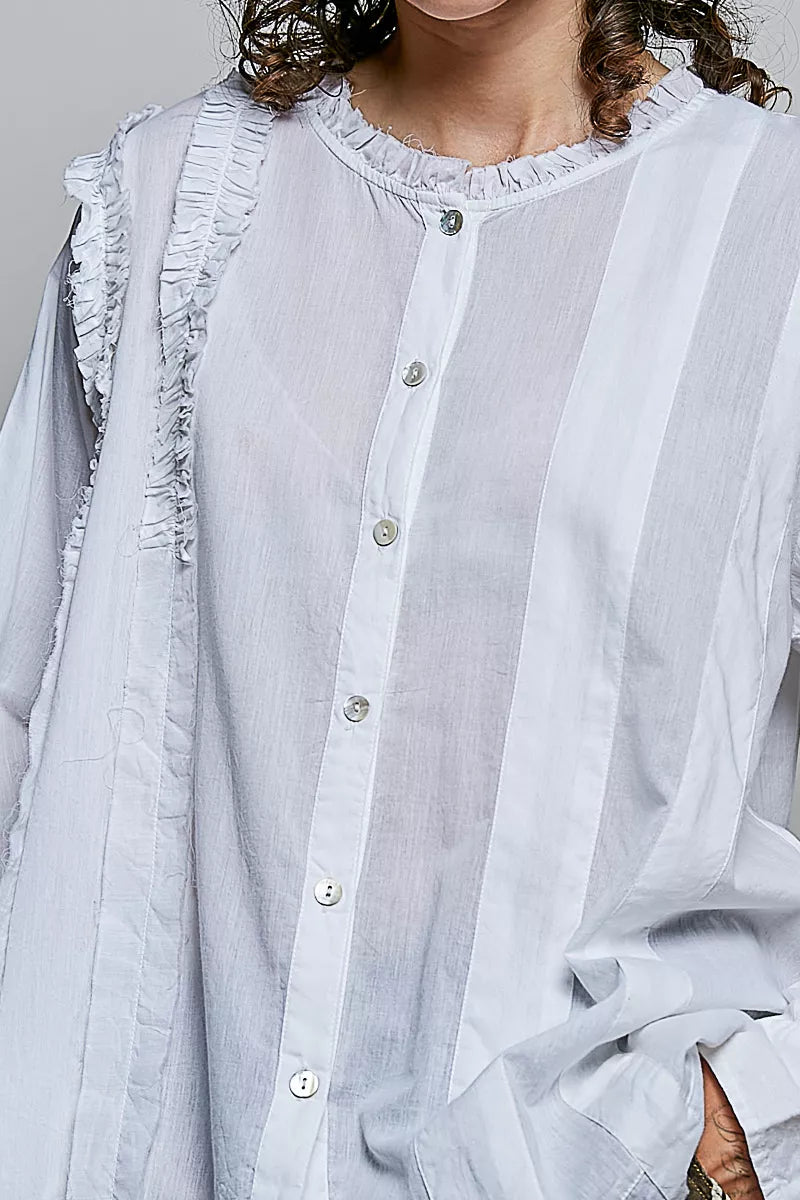 Ivory lightweight woven shirt close-up: ruffle-trim round neck and button placket