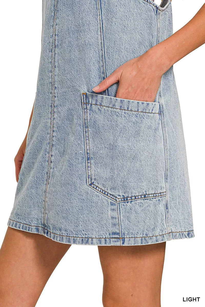 Light wash denim overall dress with large front patch pocket and contrast stitching
