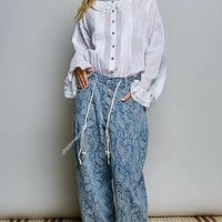 Ivory button-down shirt with long sleeves, pintuck detailing, and lace-trim cuffs