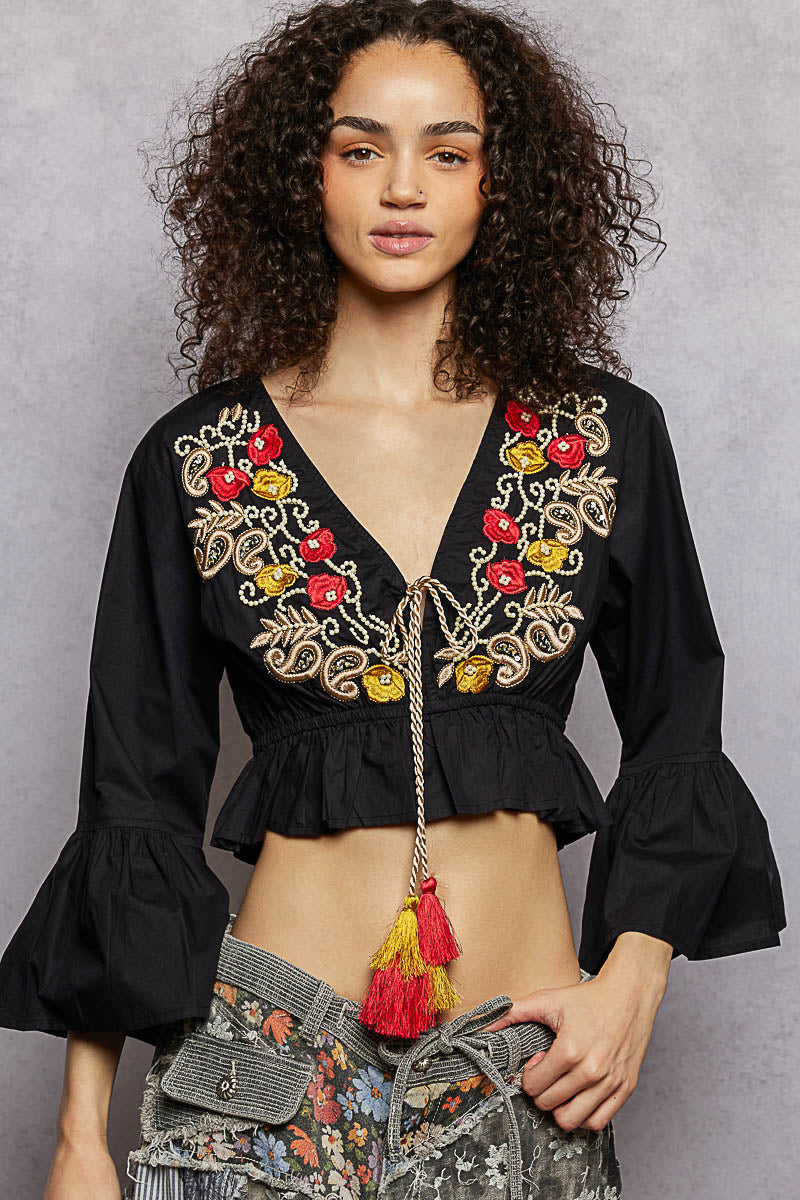 Black cropped blouse with floral embroidery at V-neck and puff sleeves