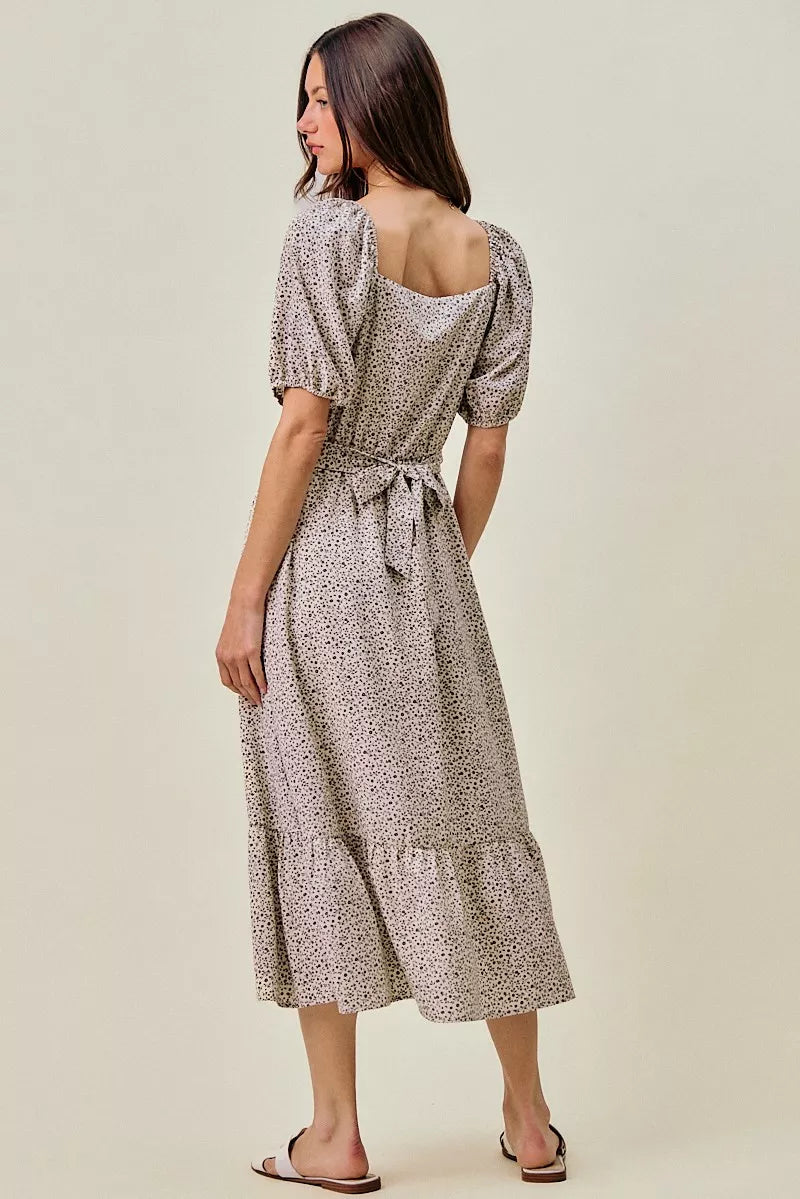 Ditsy floral midi dress from back view, puff sleeves and tied self-belt at waist