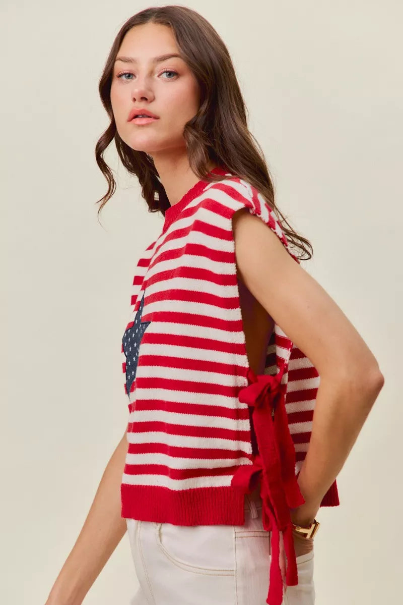 Red and ivory striped sleeveless vest top with navy star patch and hanging side ties