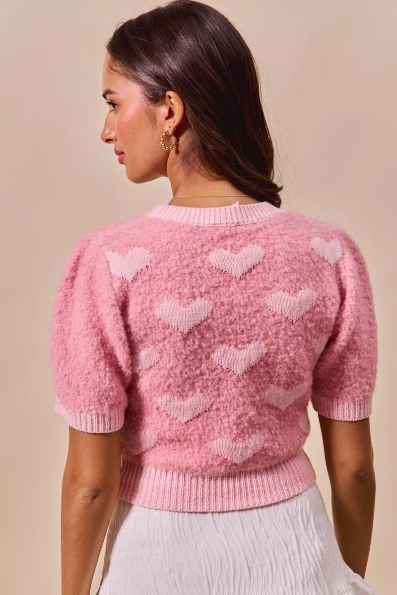 Back view: pink cropped heart-print knit sweater with crew neck, short sleeves