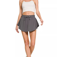 Ash grey woven active skort with elastic waistband and drawstring bow