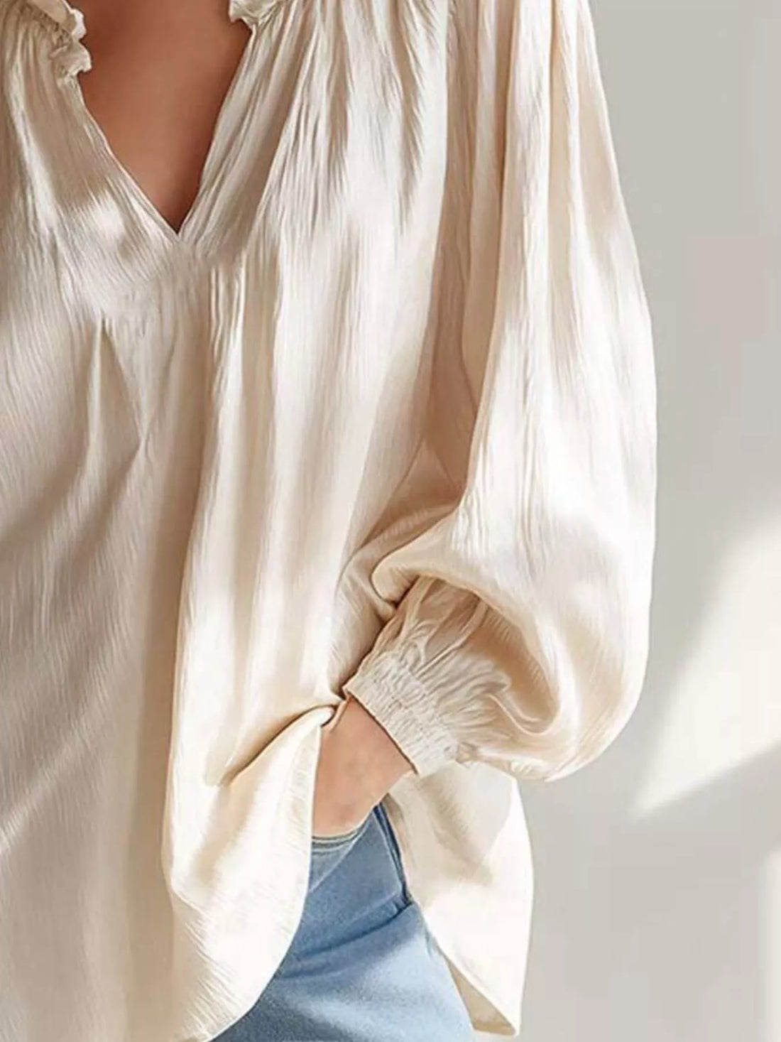 Beige ruffle-trim blouse with V-neck and ruffled long cuff sleeves