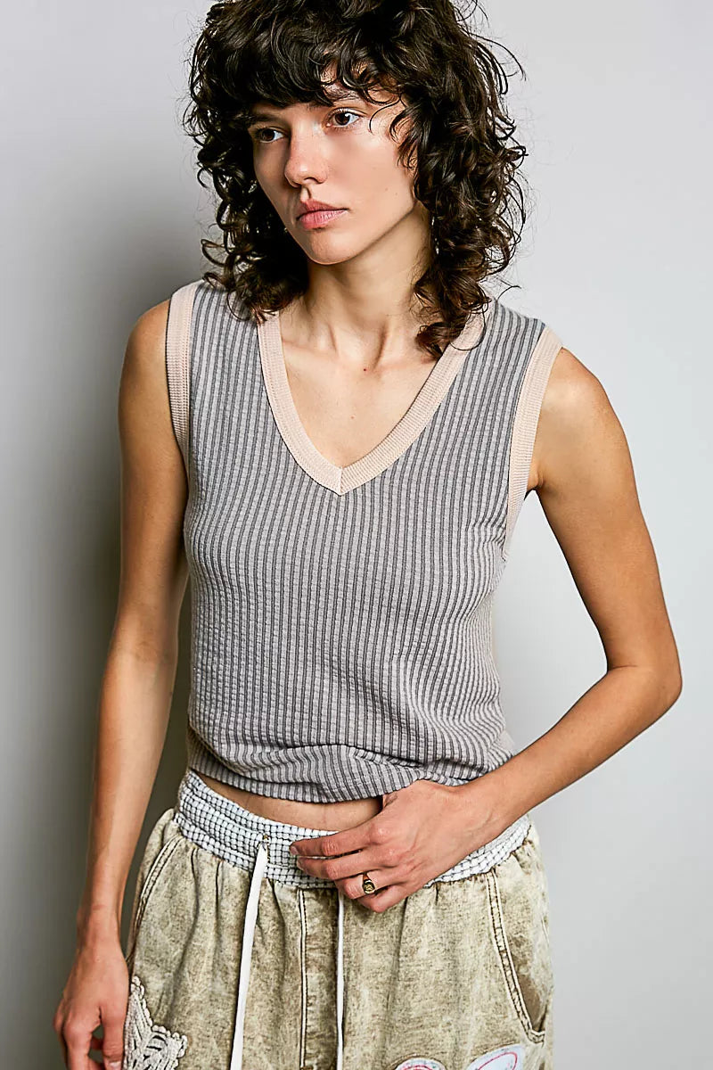Light grey ribbed V-neck sleeveless tank with contrast neckline trim.