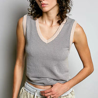 Light grey ribbed V-neck sleeveless tank with contrast neckline trim.