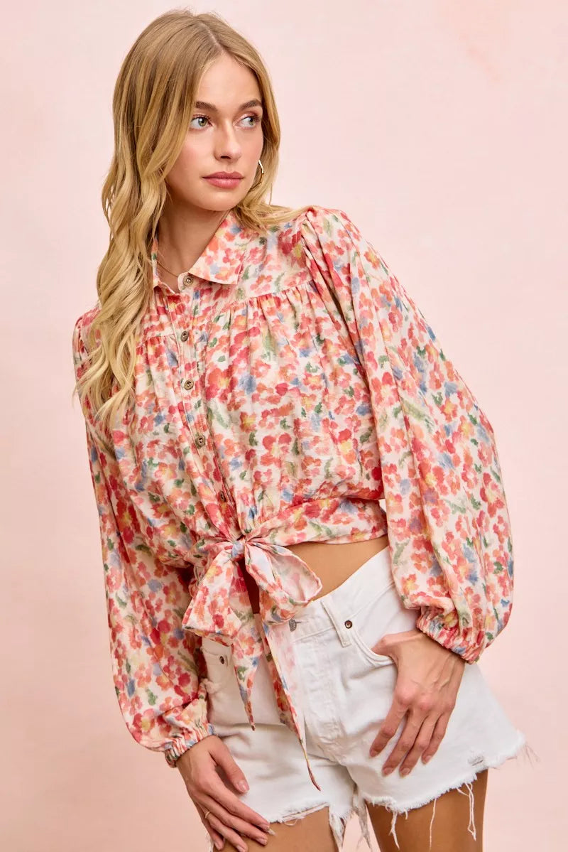 Floral print crop shirt with button front, puff sleeves, and tied hem detail
