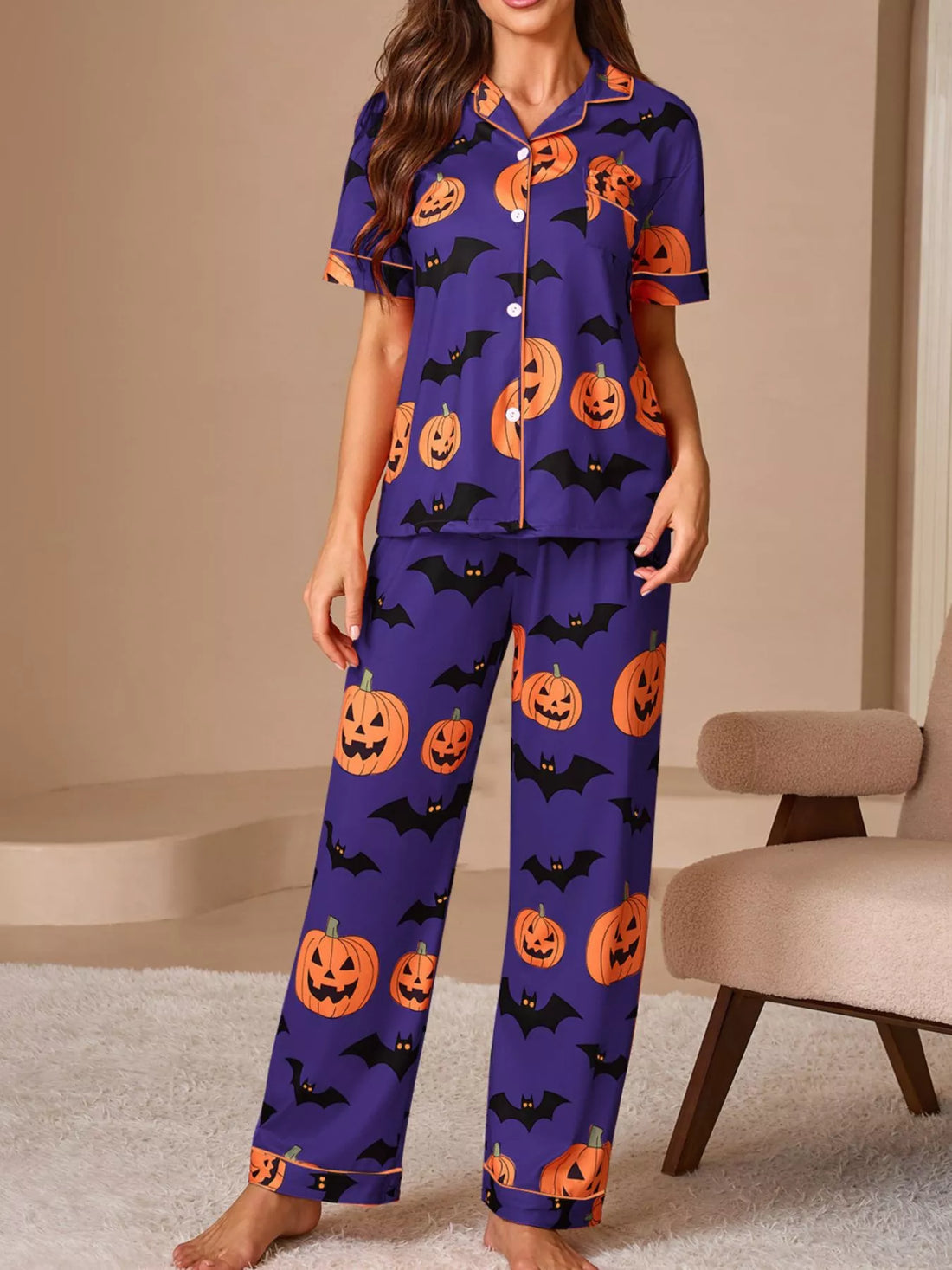 Halloween pajama set: purple button-down short-sleeve top and matching pants with orange pumpkin bat print