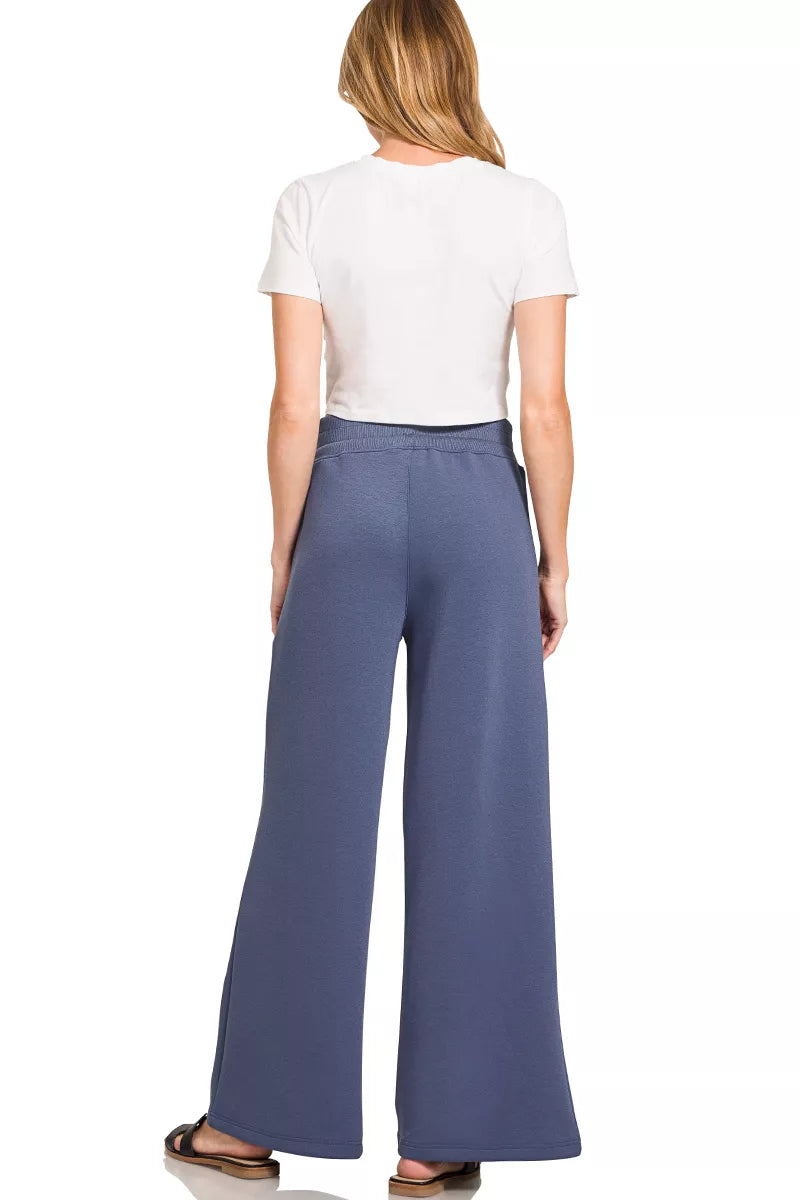 Back view: off-white short-sleeve cropped top and blue indigo wide-leg center-seam pants
