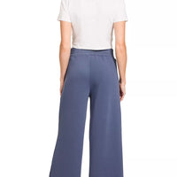 Back view: off-white short-sleeve cropped top and blue indigo wide-leg center-seam pants