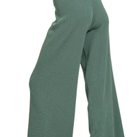 Teal-green wide-leg pants with elastic waistband and flowing drape