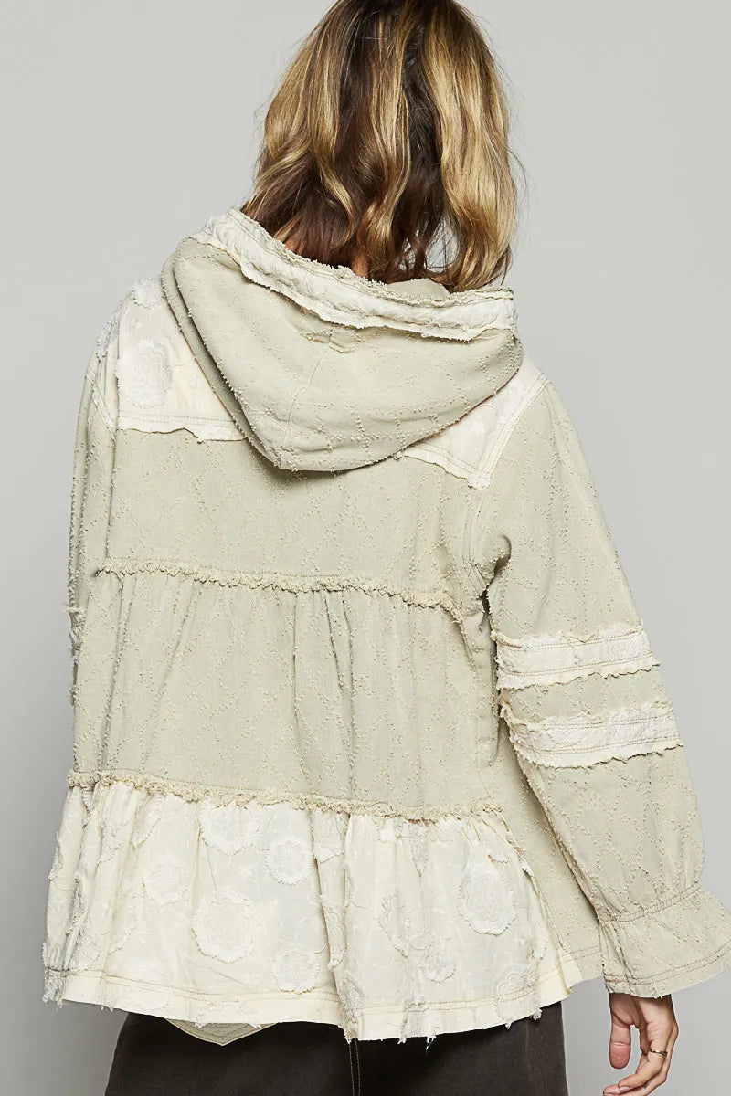 Beige hooded jacket with raw hem; back panel seams and gathered tier details