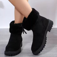 Black faux fur ankle boots with side-zip, bow detail, and thick lug platform sole