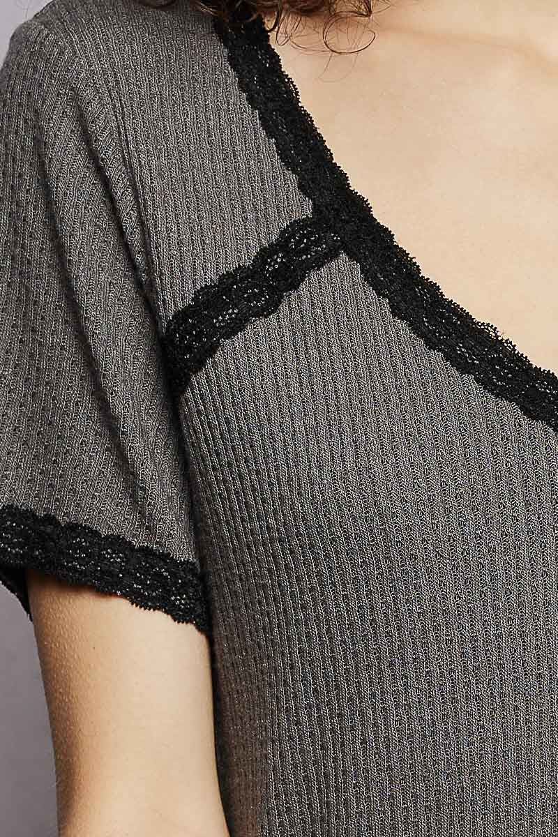 Charcoal textured knit top with black lace edging along the V-neck and sleeve hem