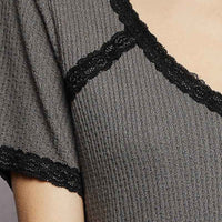 Charcoal textured knit top with black lace edging along the V-neck and sleeve hem