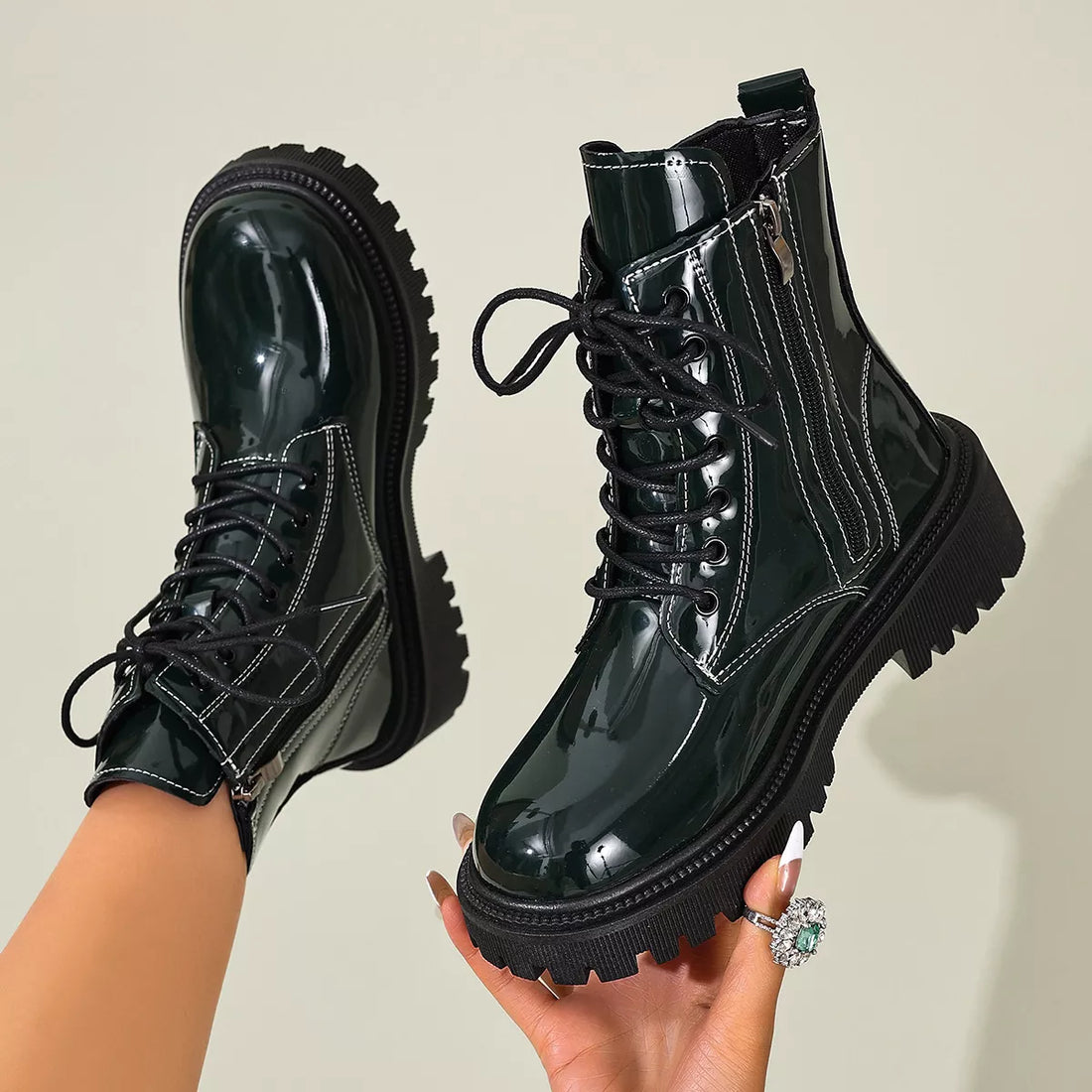 Dark green glossy lace-up block heel boots with black trim and thick lug sole
