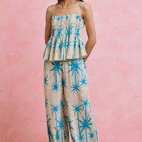Blue palm tree print adjustable cami top with smocked bodice and layered ruffles