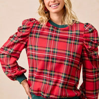 Red plaid top with exaggerated puff shoulders and green crew neckline