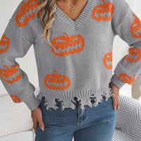 Gray pumpkin sweater with orange knit motifs, V-neck, and fringe distressed hem