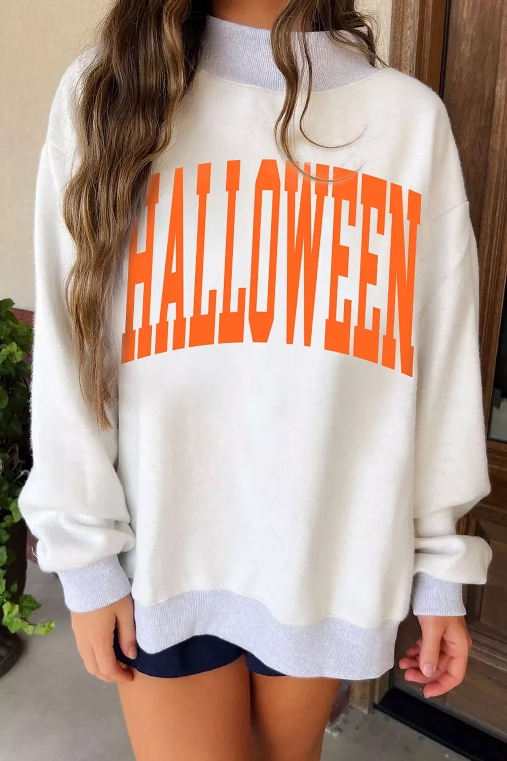 Light gray sweatshirt with large orange “HALLOWEEN” graphic, mock neck