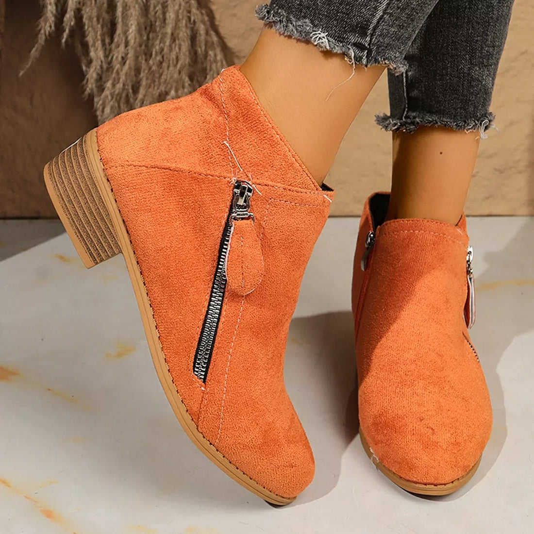 Orange suede point-toe block heel ankle boots with side zipper