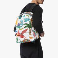 Kids dinosaur backpack worn on back in profile, multicolor dinosaur print and black straps