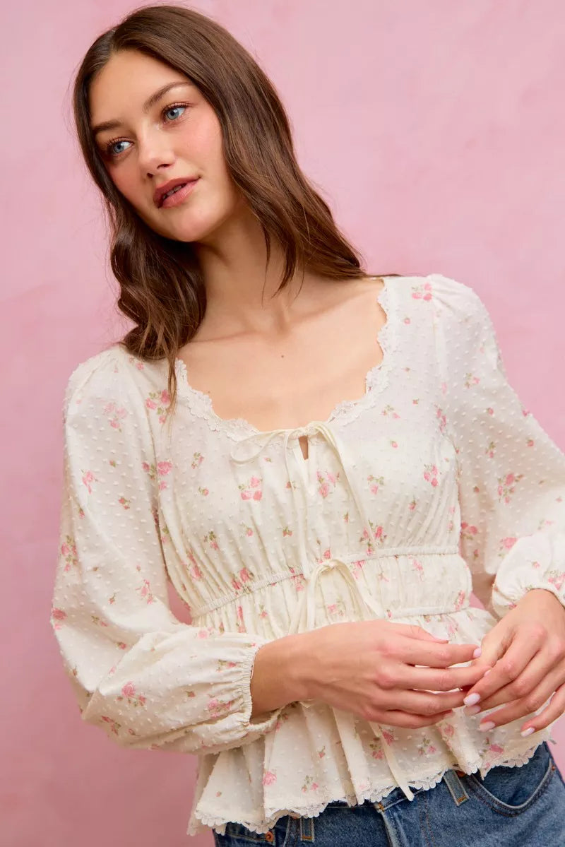 White floral clip-dot blouse featuring scalloped lace trim along the neckline and cuffs