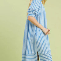 Blue-and-white striped midi dress, side view with tiered hem.
