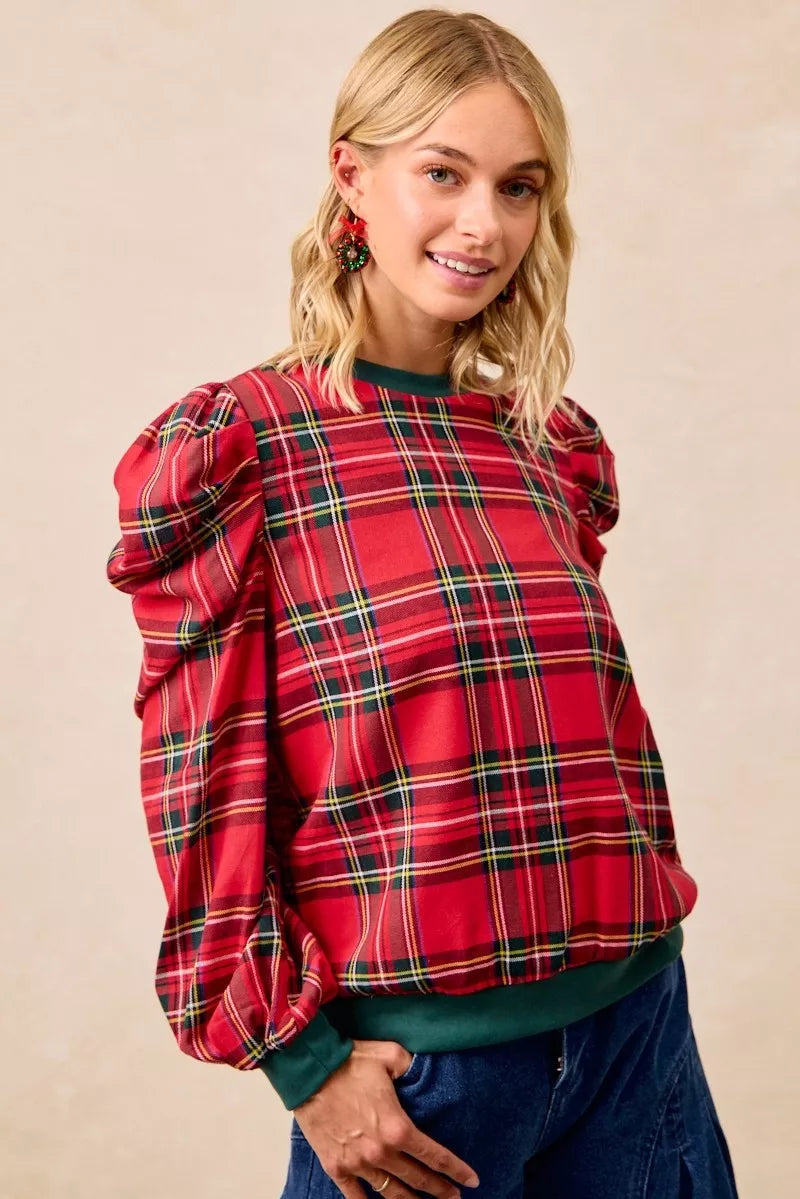 Red plaid top with puff sleeves and exaggerated shoulders, green ribbed crew neckline