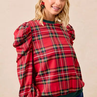 Red plaid top with puff sleeves and exaggerated shoulders, green ribbed crew neckline