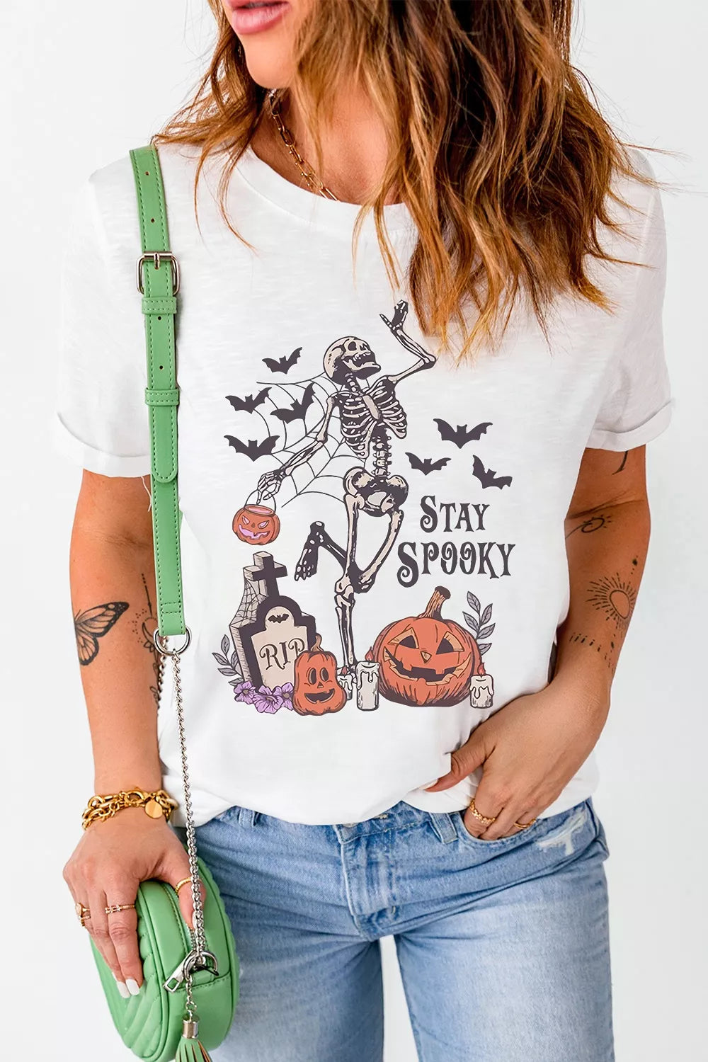 White Halloween graphic T-shirt front featuring skeleton, jack-o&