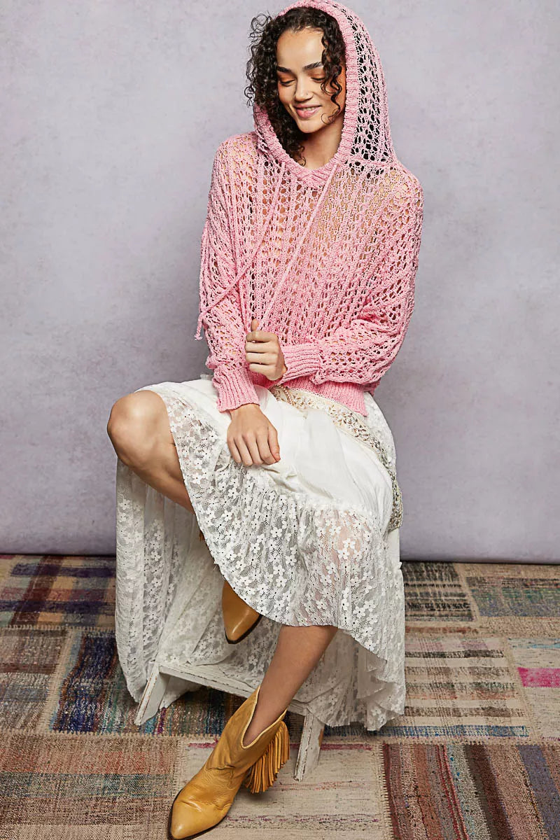 Pink openwork knit top with hooded neckline and long sleeves, high-low hem