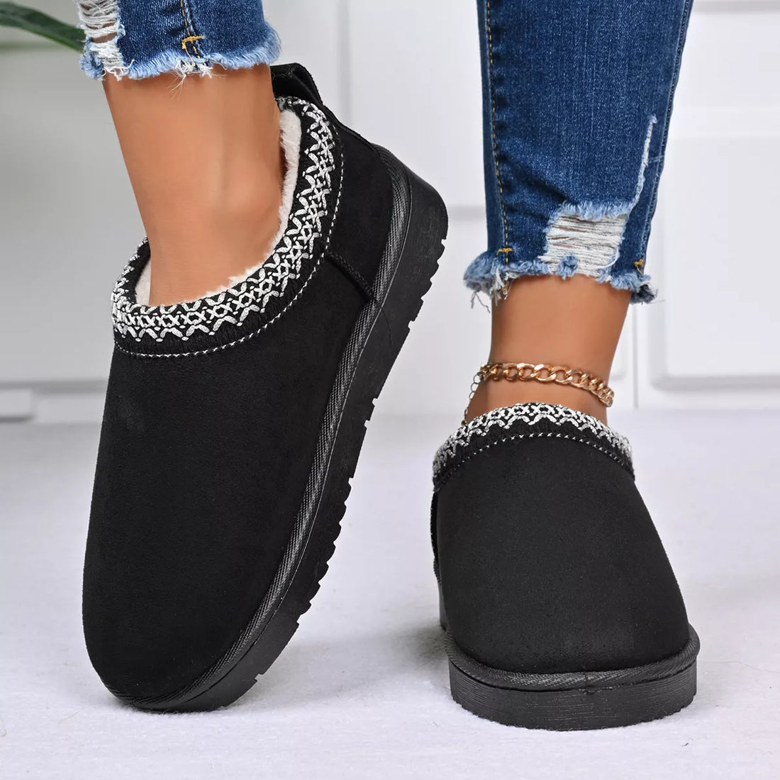 Black platform ankle boots with patterned trim and low block platform sole