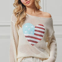 Off-white knit sweater with American flag heart sequin patch, wide neckline.