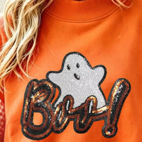 Orange sweatshirt close-up: sequin 'Boo!' ghost patch on front