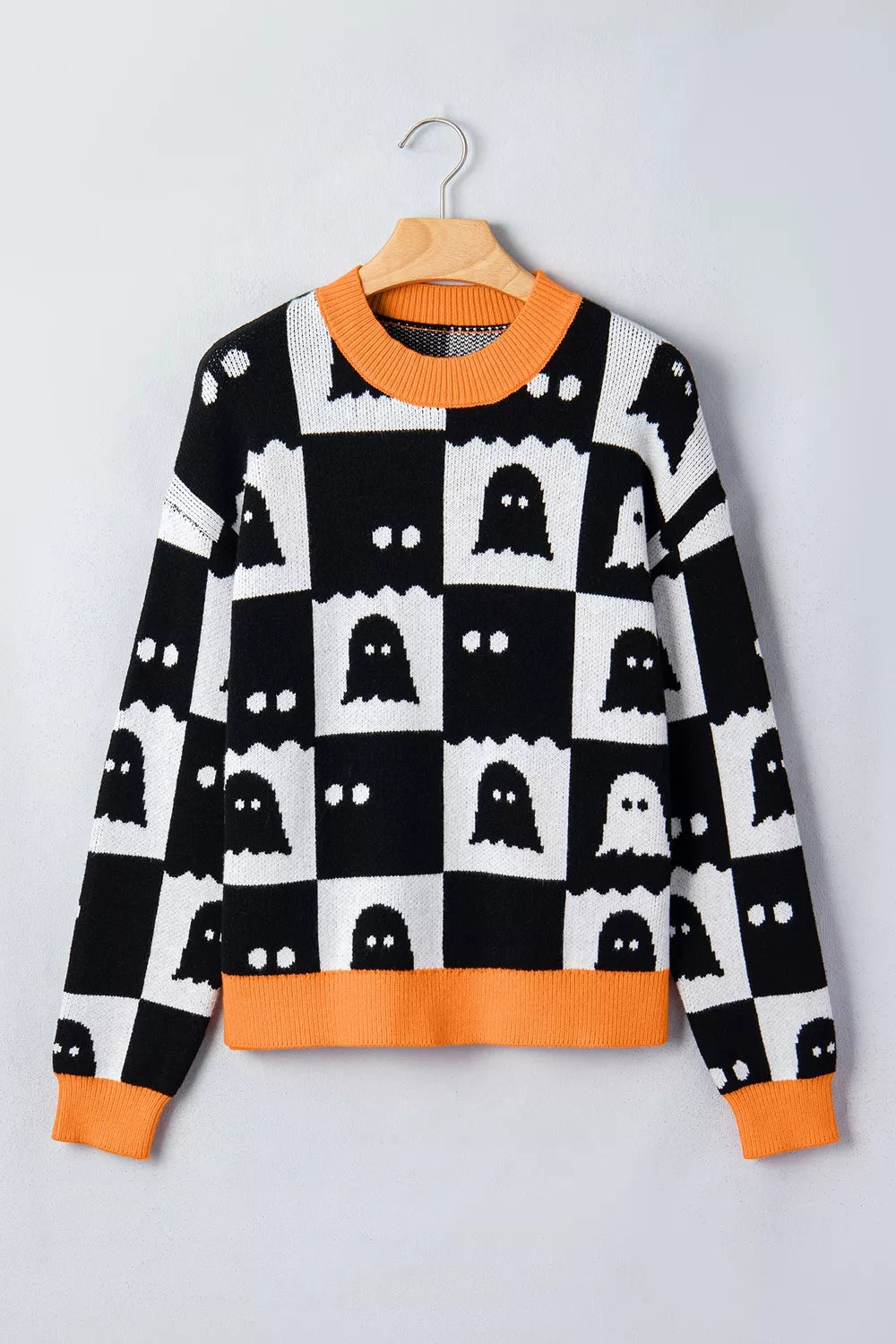 Ghost checkerboard sweater, black and white knit with orange ribbed crew neck