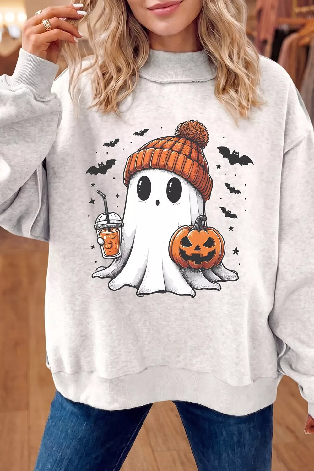 Reversible white mock neck tunic sweatshirt with ghost holding orange jack-o-lantern graphic