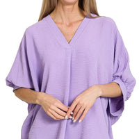 Lavender V-neck woven top with puff half-sleeves and relaxed drape