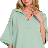 Dusty green collared short-sleeve pullover with V-neck and relaxed fit