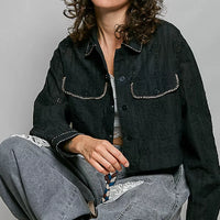 Black cropped button-front eyelet cotton jacket with scalloped pocket flaps and contrast trim.