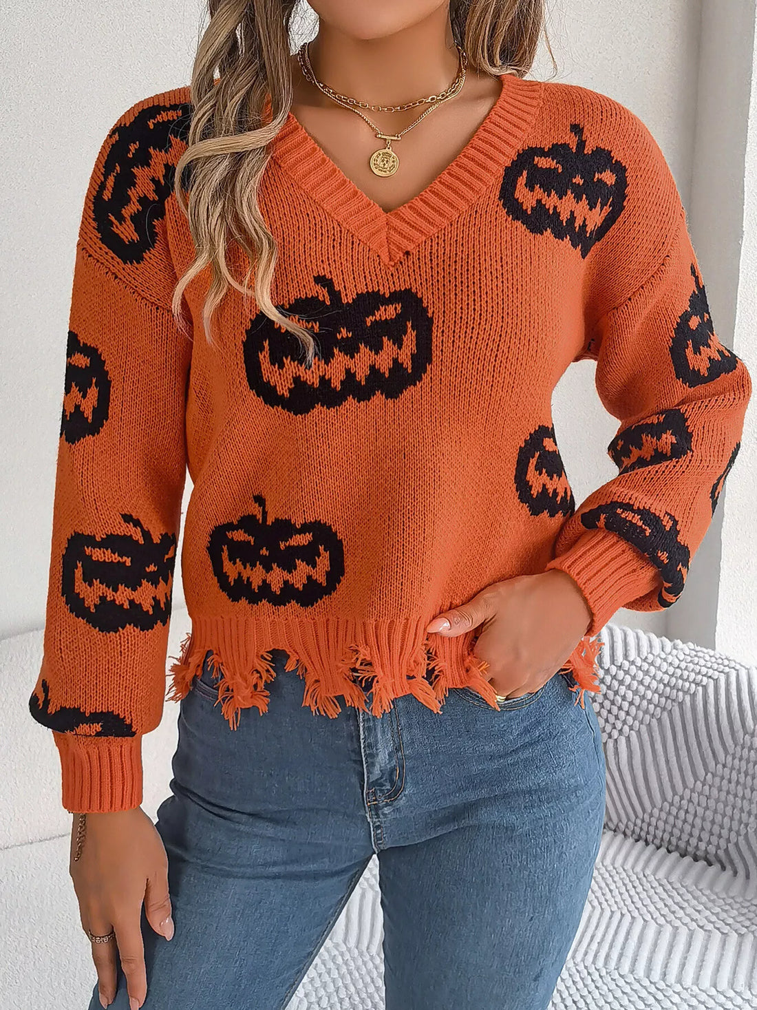 Orange pumpkin print distressed hem V-neck sweater with long sleeves
