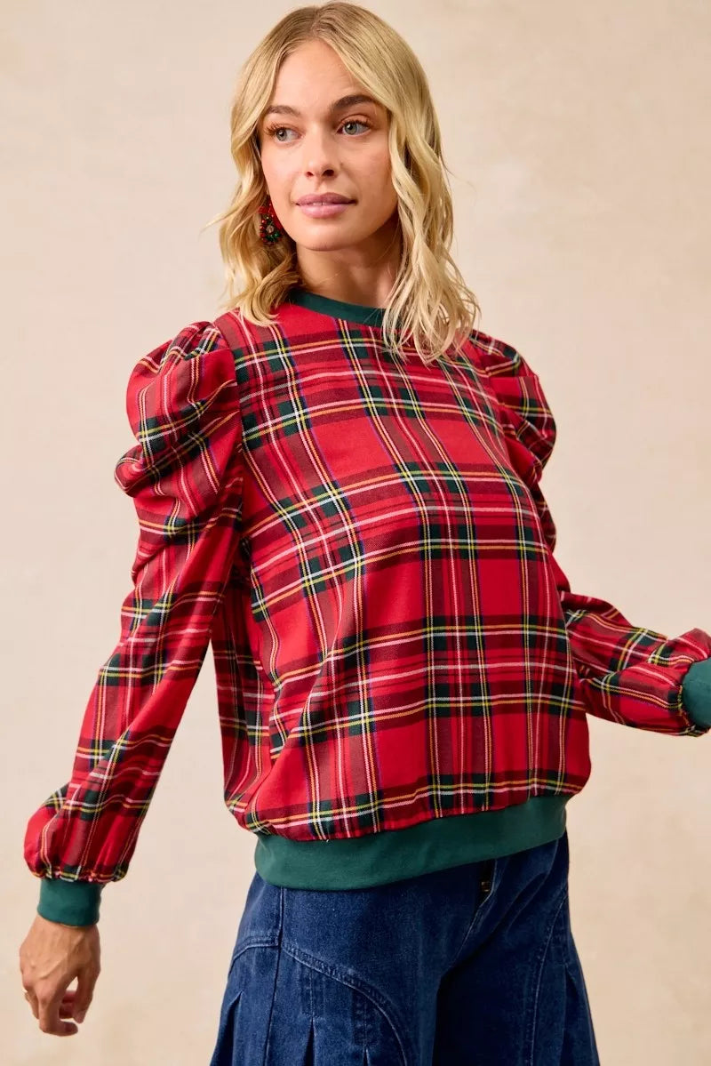 Red plaid puff-sleeve top with exaggerated shoulders and green ribbed cuffs at wrists