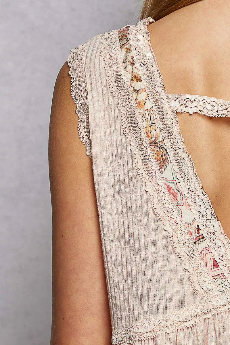 Pale pink sleeveless top close-up: lace-trim panel with floral embroidery edging
