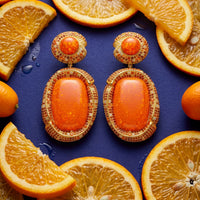 Gold fire opal drop earrings with oval orange cabochons and jeweled halo detailing